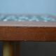 1970s coffee table with a tapered teak base and ceramic mosaic.