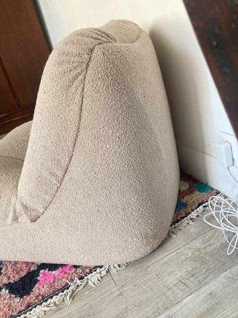 Vintage armchair reupholstered in boucle fabric.