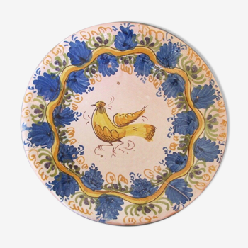 Faience dish decorated with yellow bird on a blue background