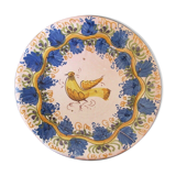 Faience dish decorated with yellow bird on a blue background