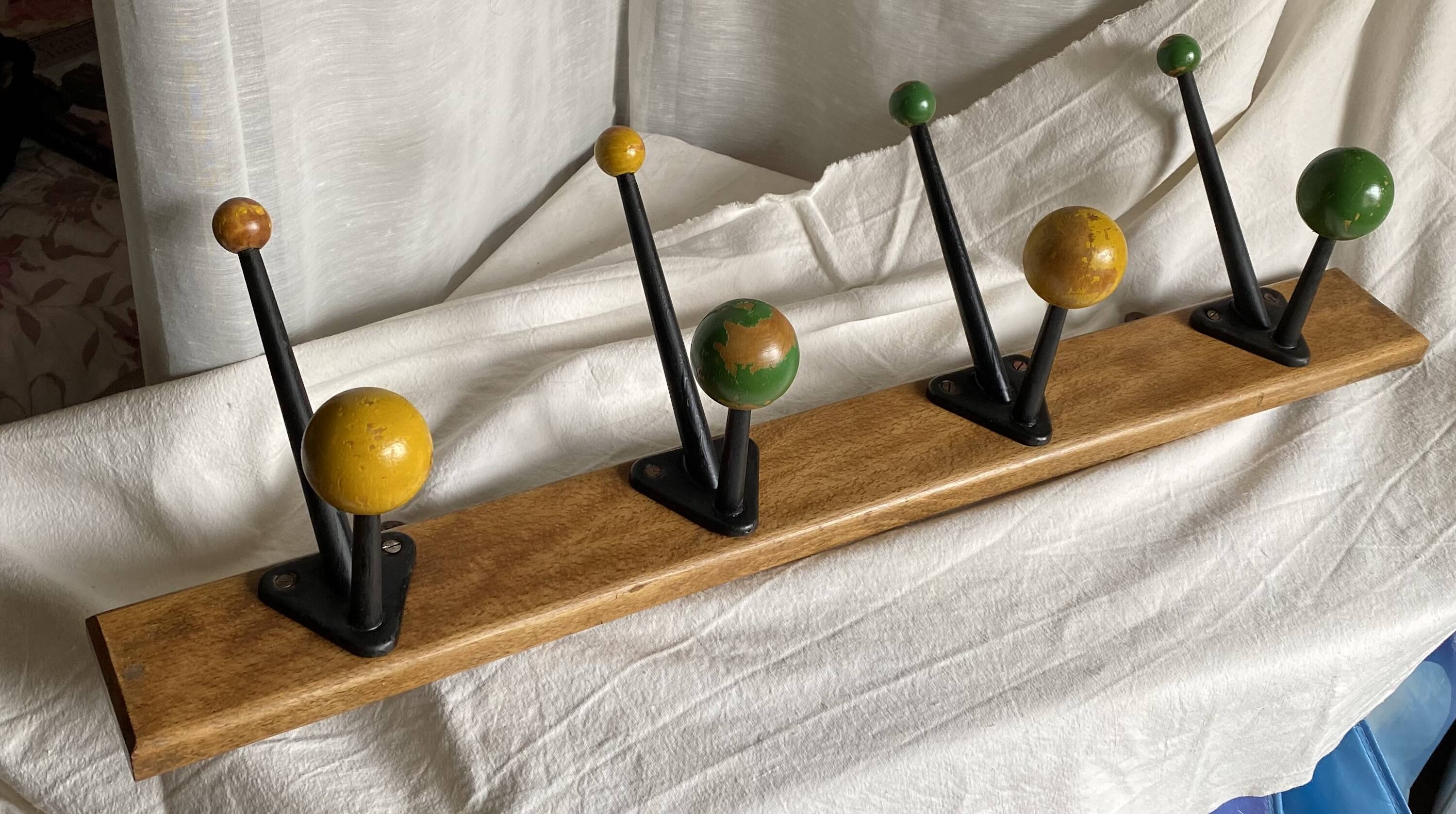 Coat rack with 5 double metal hooks and vintage wooden balls from the 1950s.