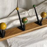 Coat rack with 5 double metal hooks and vintage wooden balls from the 1950s.