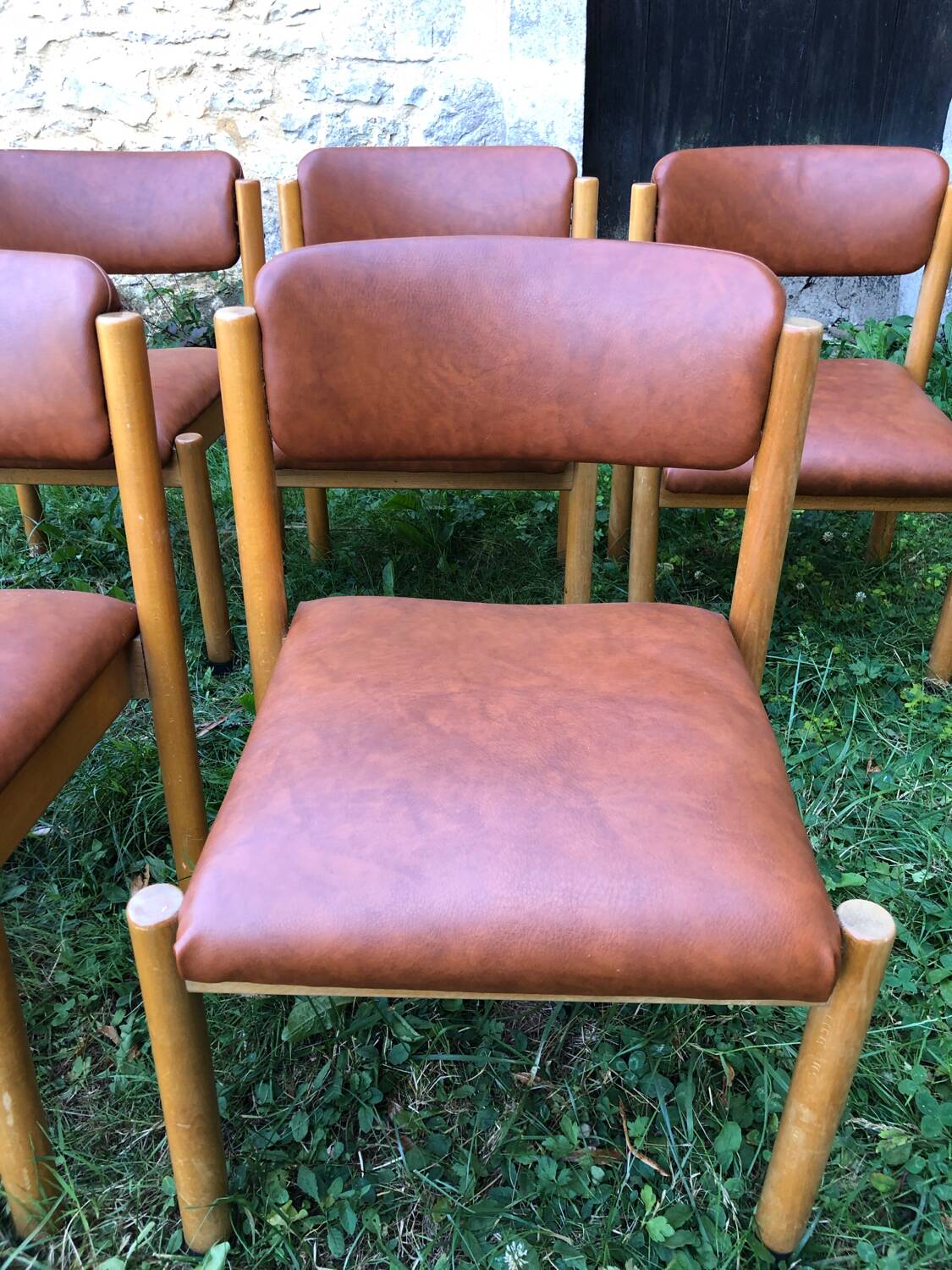 Six wooden and leatherette chairs
