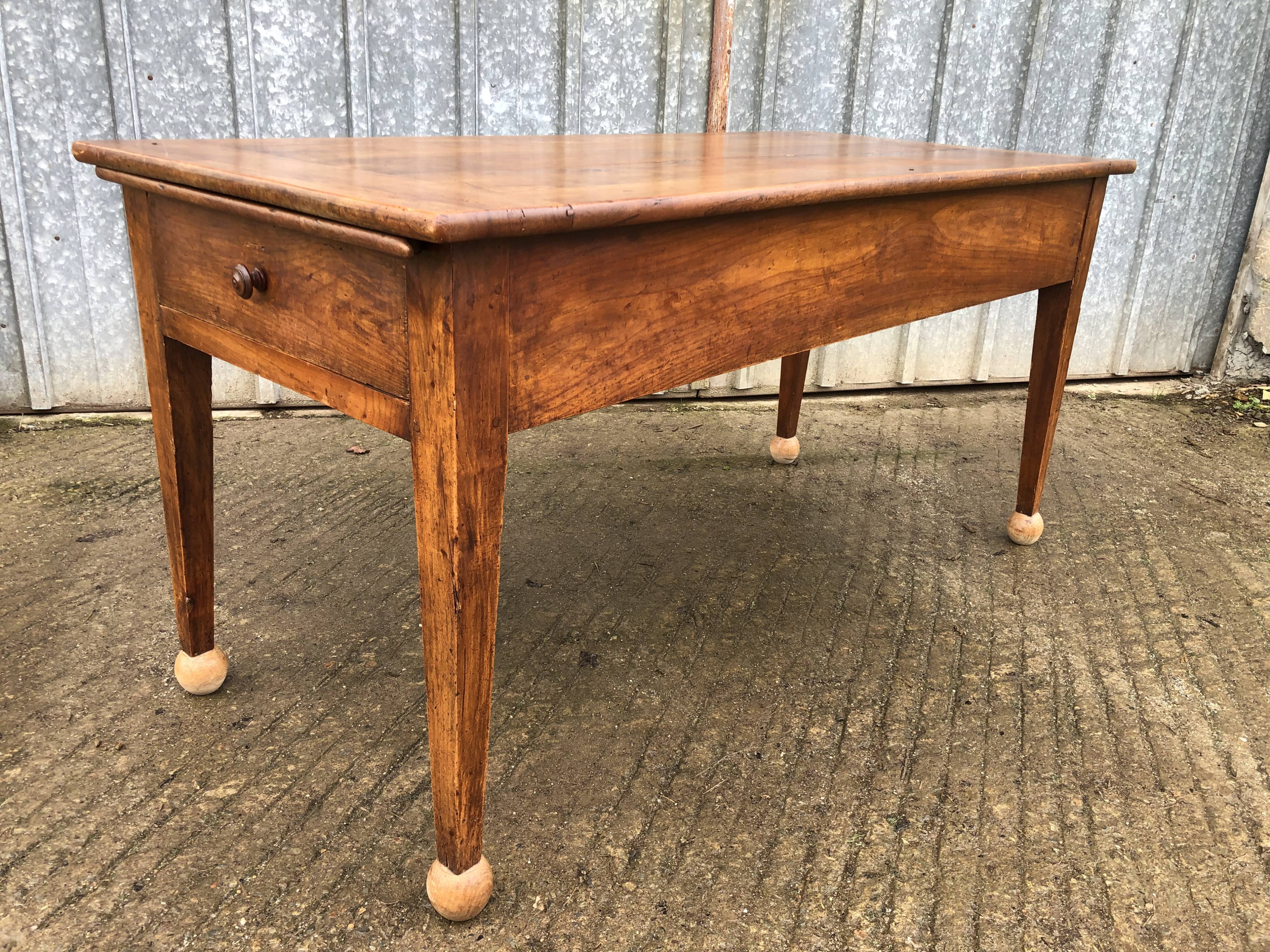 Antique solid cherry farmhouse table with 2 end drawers and 1 pull-out.