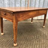 Antique solid cherry farmhouse table with 2 end drawers and 1 pull-out.