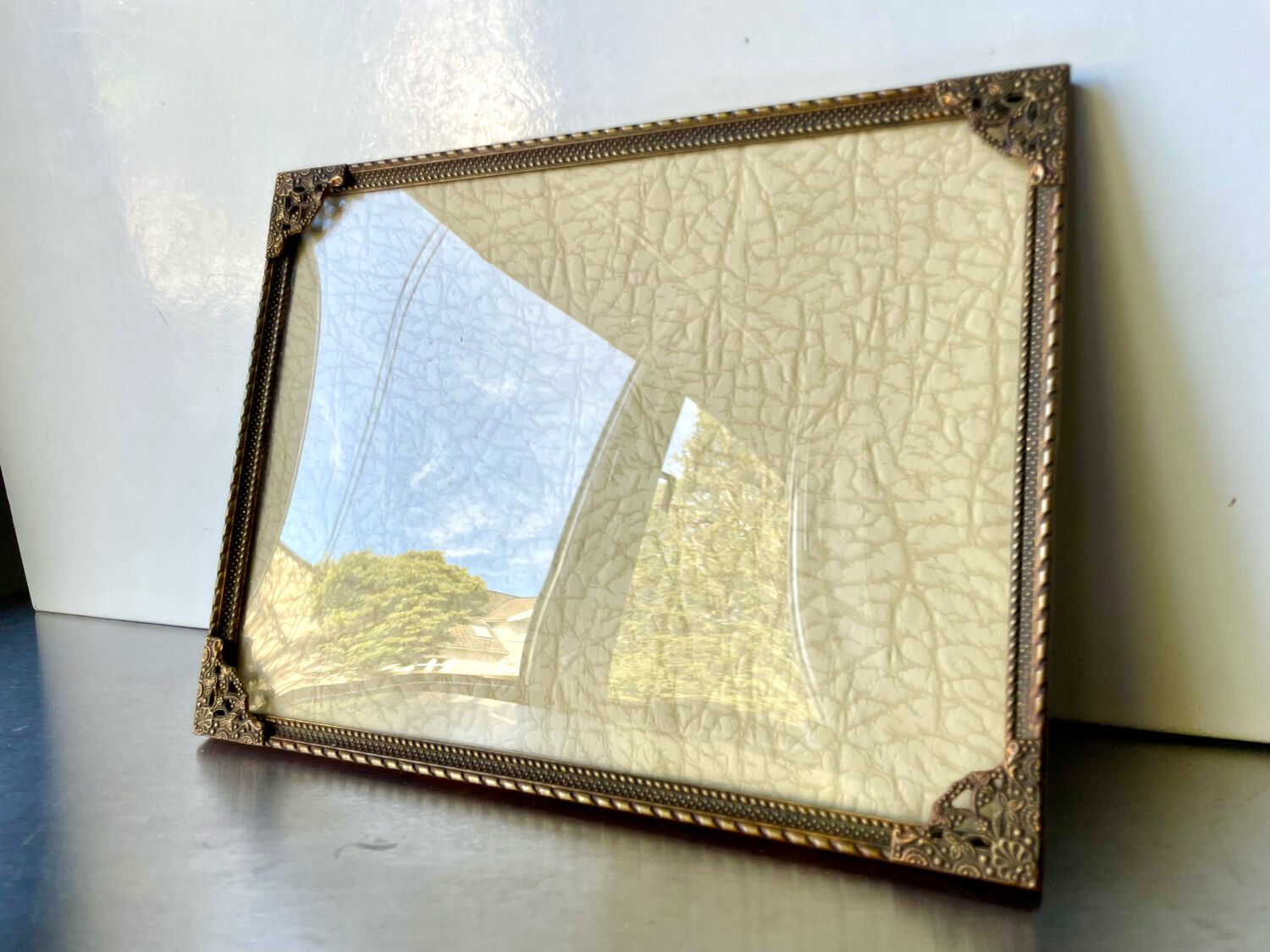 Metal frame in gold colored brass