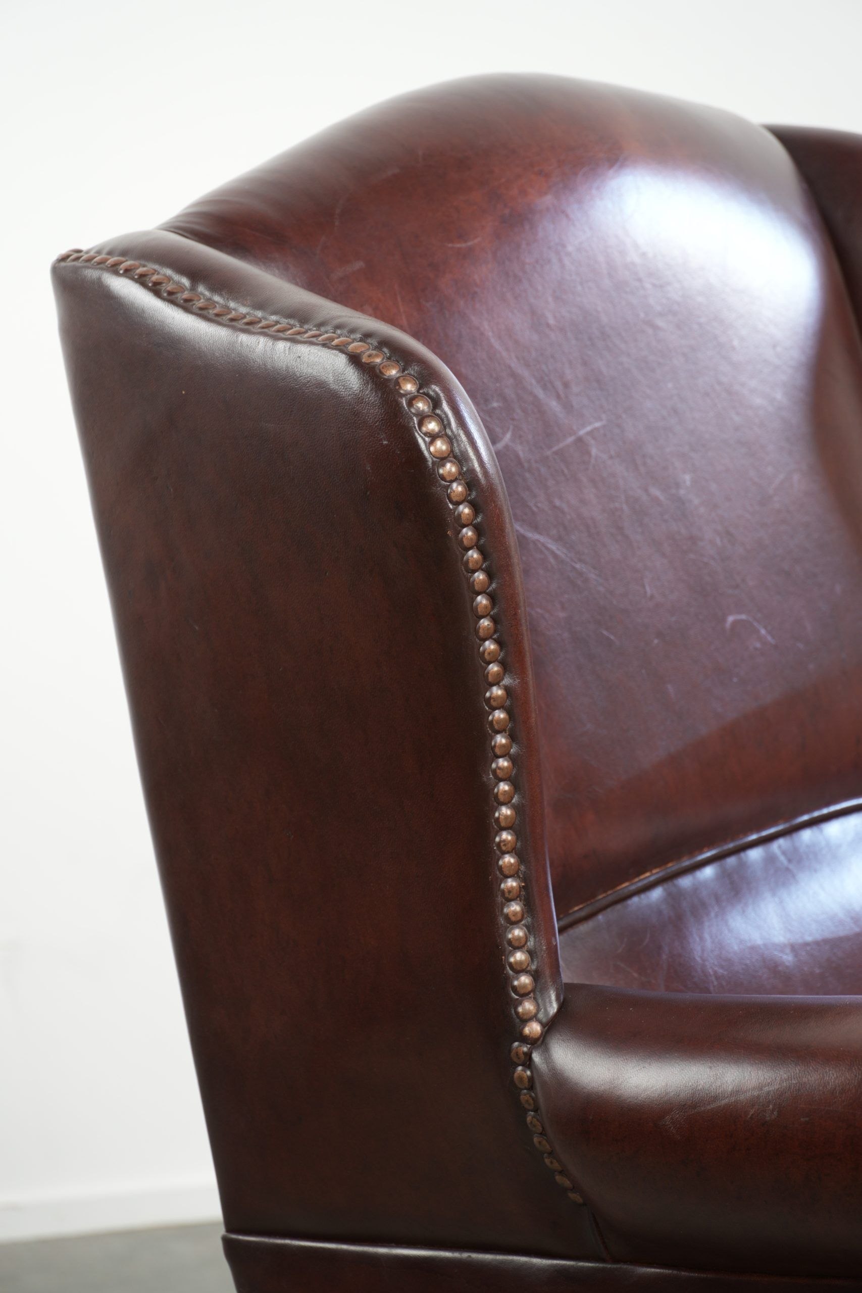 Vintage sheepskin wingback armchair with a timeless English look
