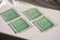 Set of 4 small square green glass plates/bowls