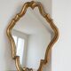 Antique mirror with a gilded wooden frame.
