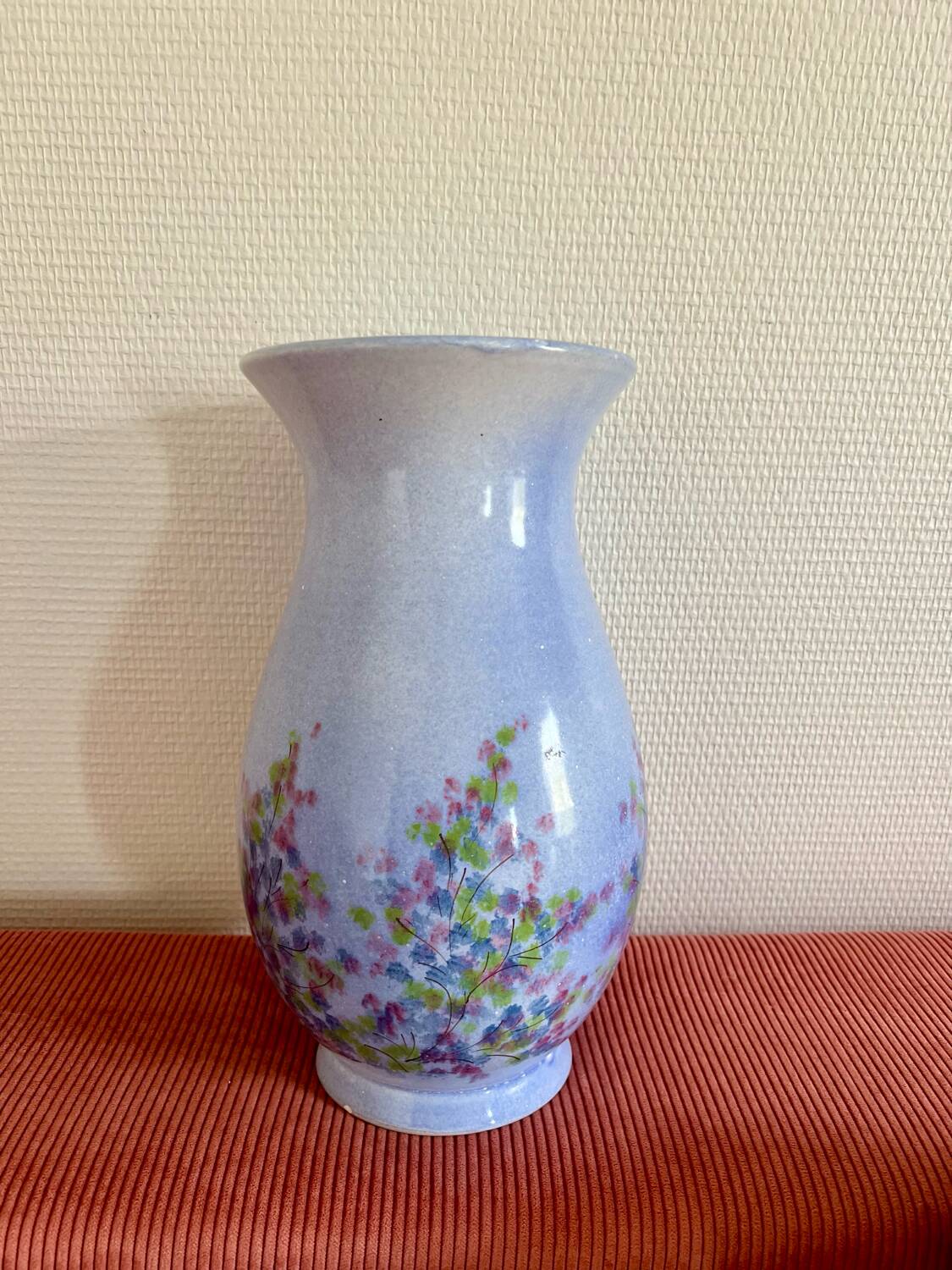 Large blue vase with pastel flowers