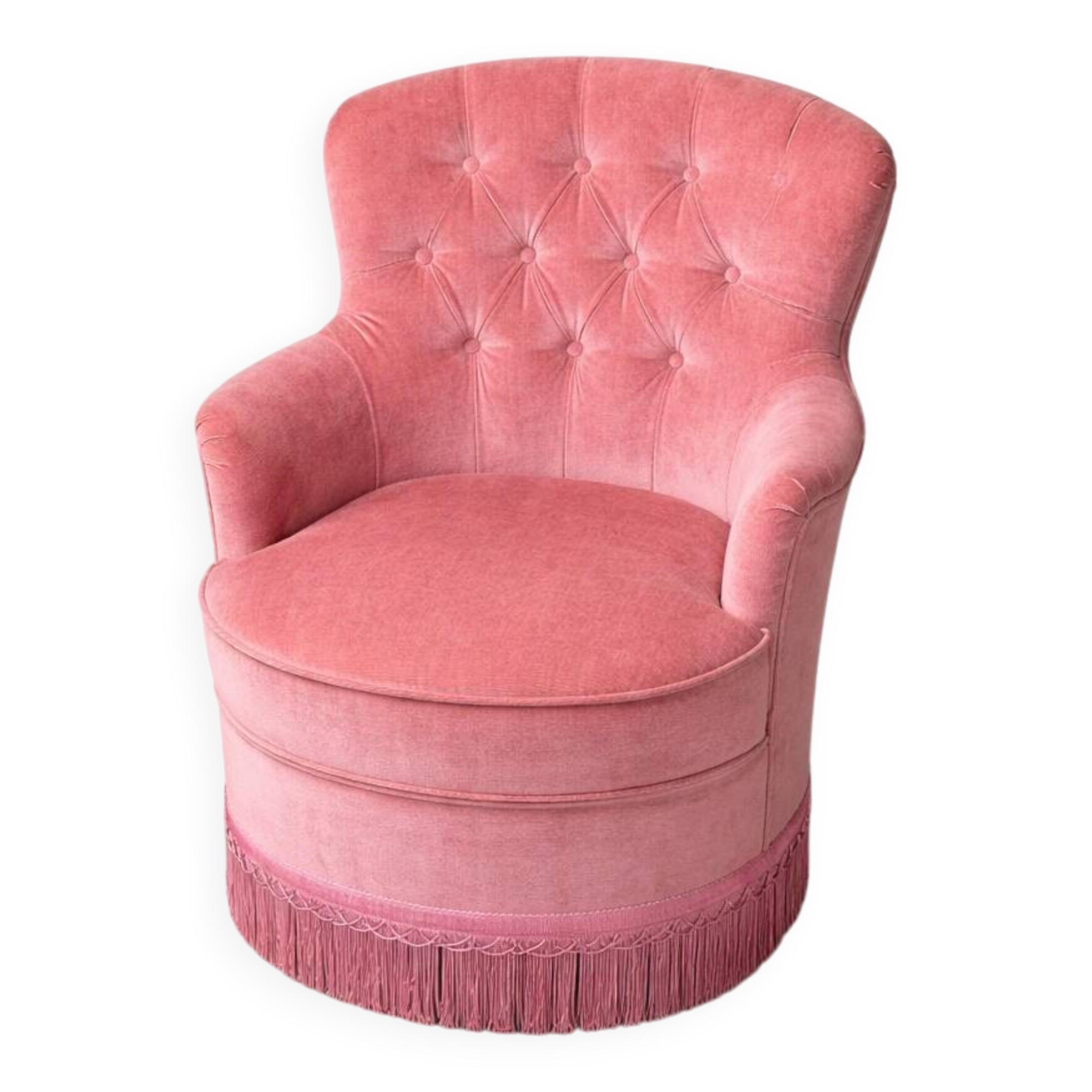 Vintage pink velvet tufted armchair with fringes.