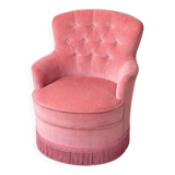 Vintage pink velvet tufted armchair with fringes.