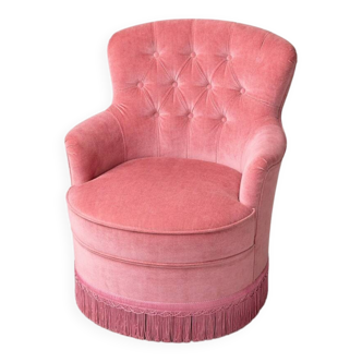 Vintage pink velvet tufted armchair with fringes.
