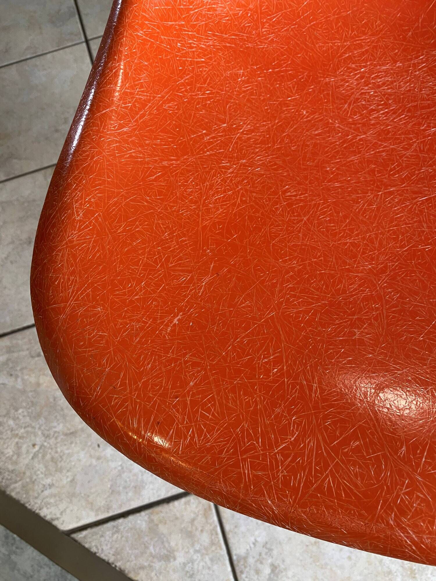 A vintage 70s Eames Herman Miller DSW Fiber Red Orange Dowel Walnut Chair