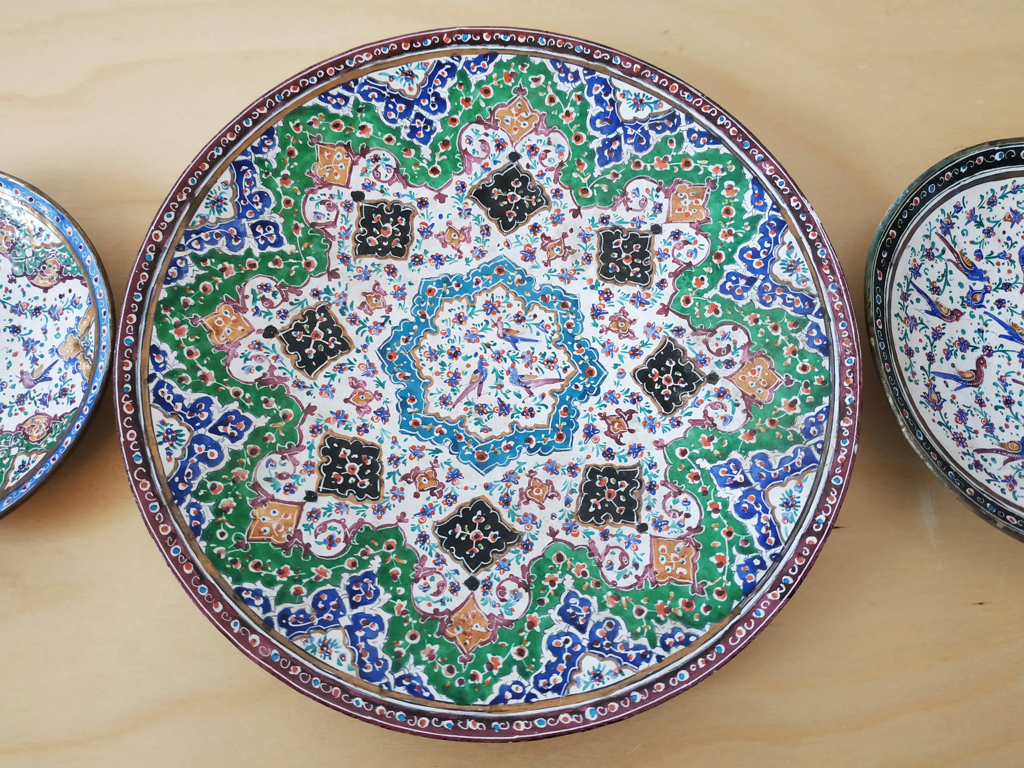 Plate and two decorative saucers enamelled with Persia decoration, circa 1940