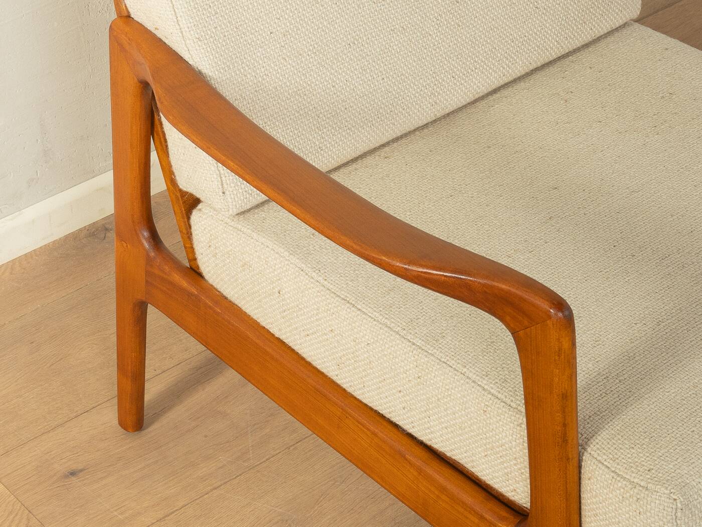 Elegant mid-century armchair from the 1960s with cream-white upholstery