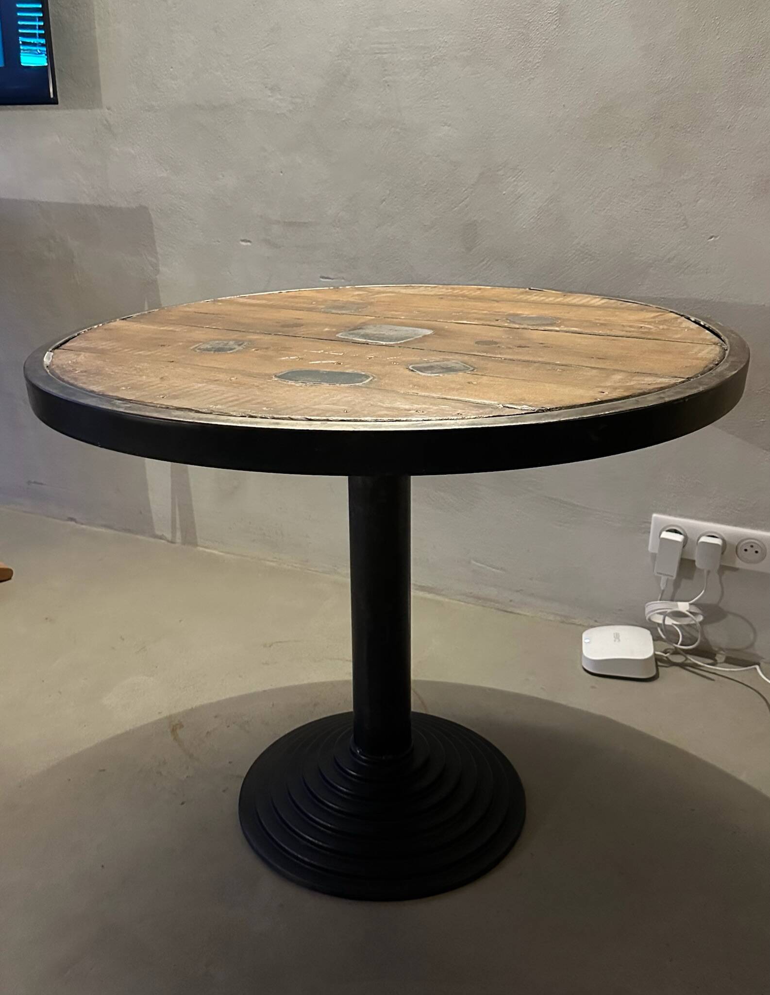 Old bistro round table / workshop – wooden top with metal rim – foot
