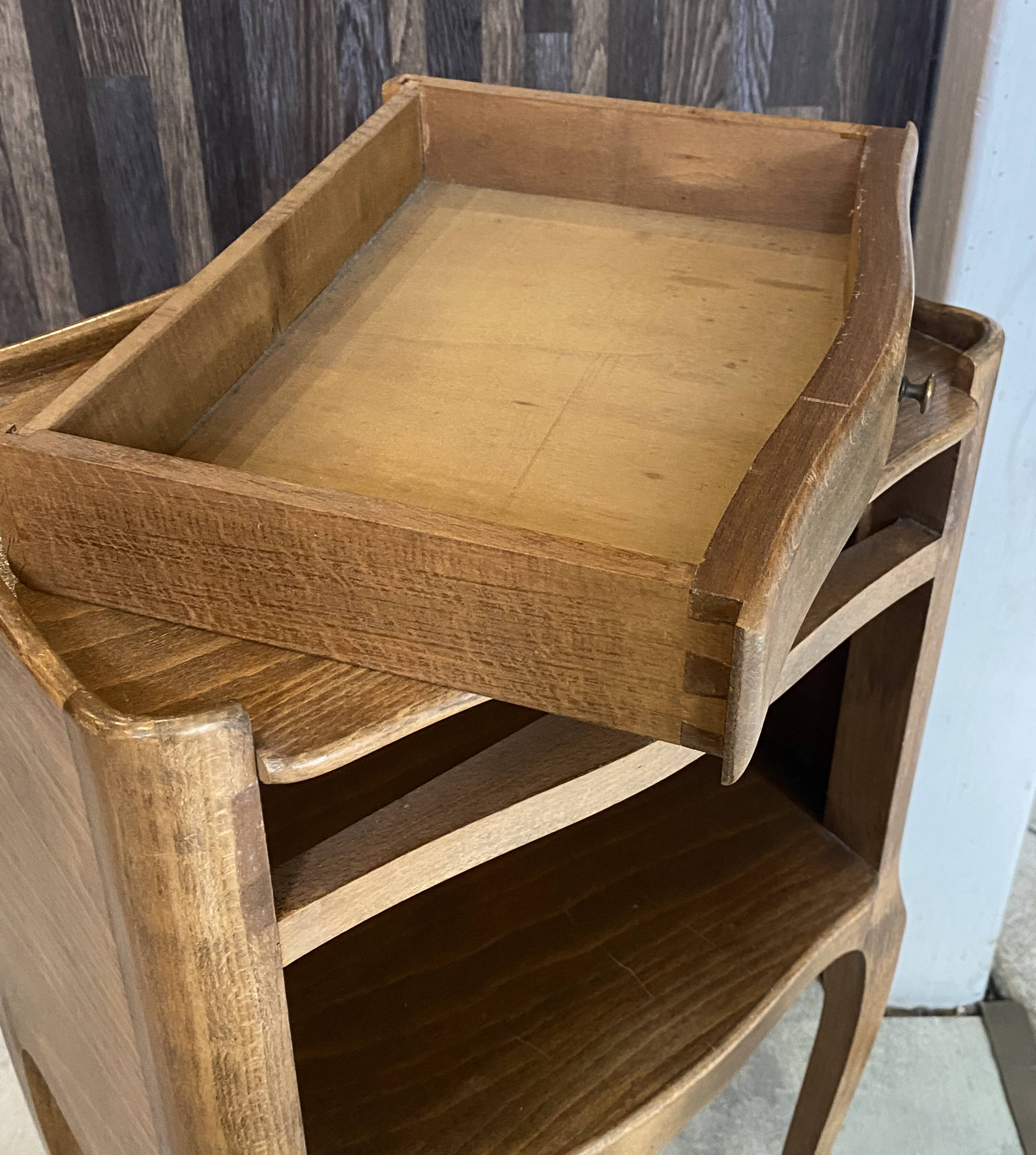 A bedside table with a drawer and a niche in Louis XV style.