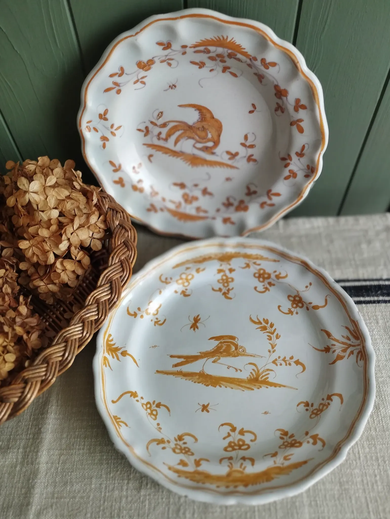 Pair of antique plates with a bird of paradise design in the style of Moustiers.