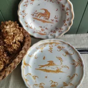 Pair of antique plates with a bird of paradise design in the style of Moustiers.