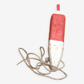 Old red and white wooden buoy