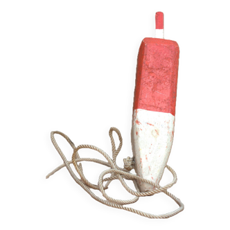 Old red and white wooden buoy