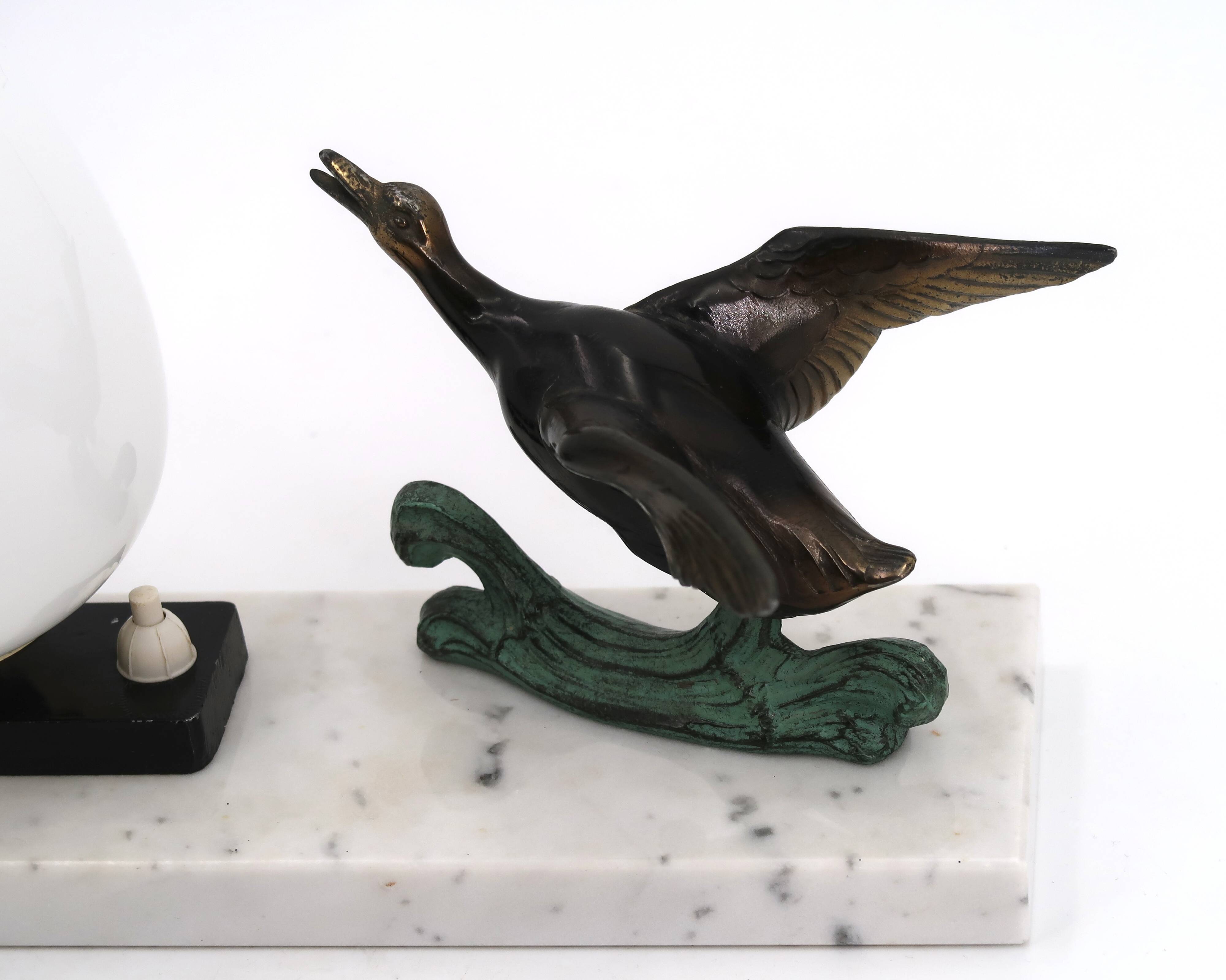 Art Deco lamp decorated with a flying duck, marble base, 1930s.
