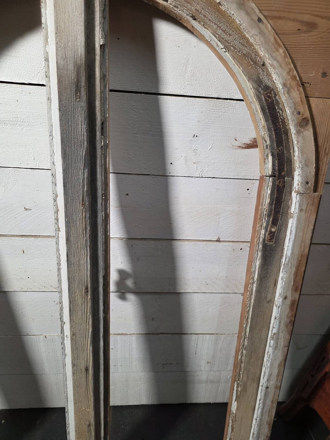 Old arched window made of fir wood