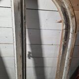 Old arched window made of fir wood