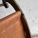 19th-century dark brown wrought-metal rocking chair with cognac leather sling seat, vintage
