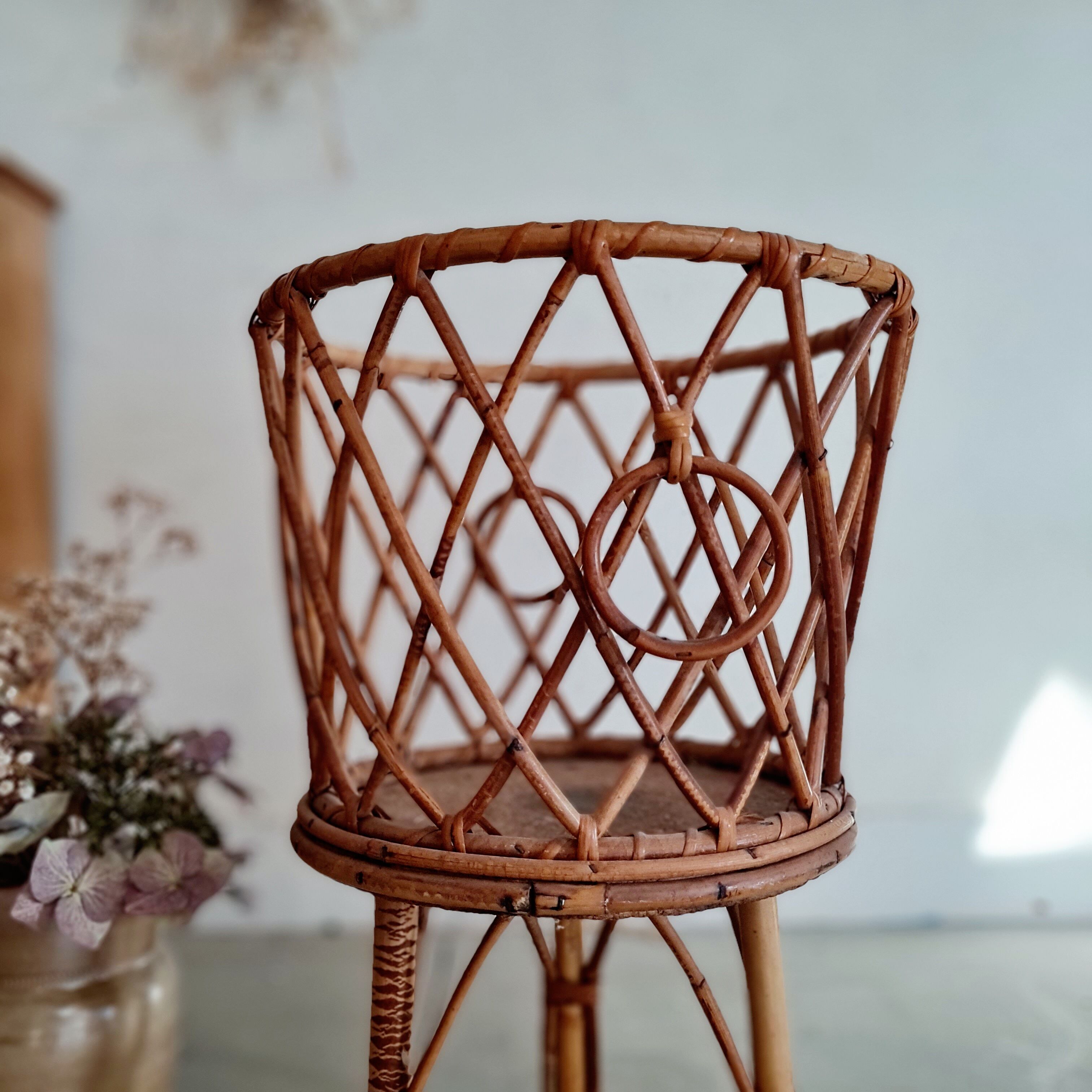 Old tripod rattan plant holder