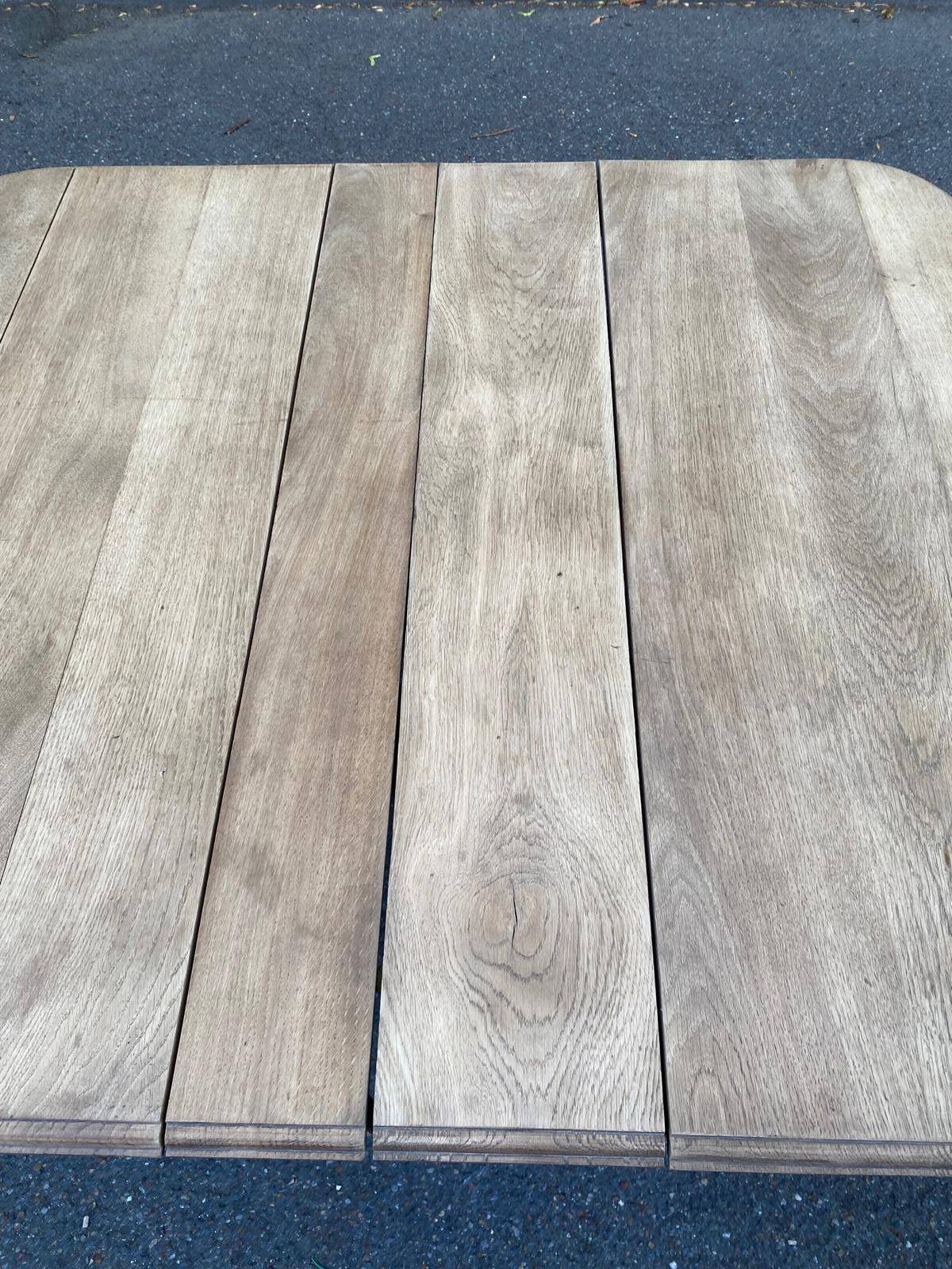 Rectangular Art Deco dining table with a central pedestal, stripped in solid oak.