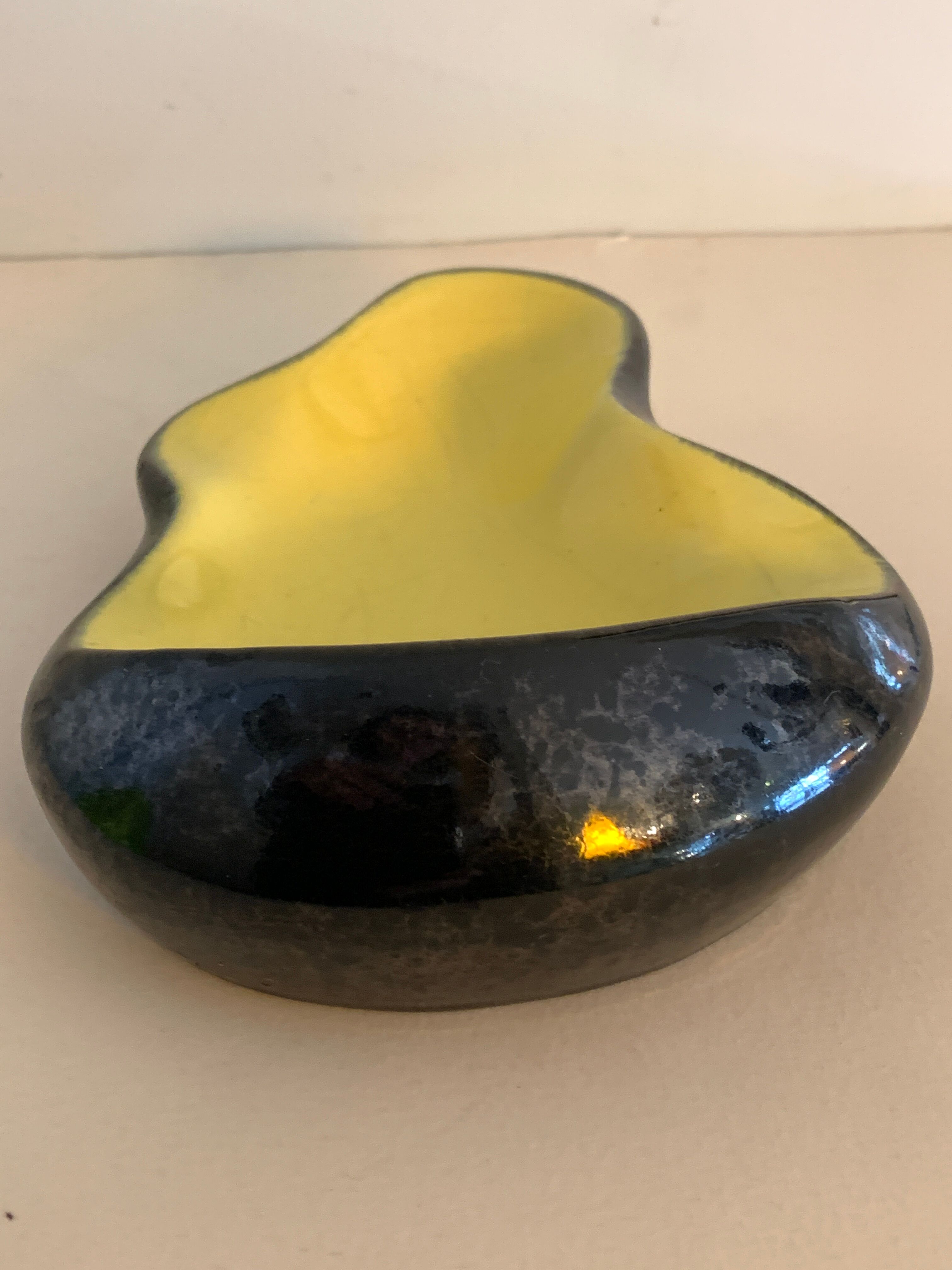 Yellow and black ceramic ashtray
