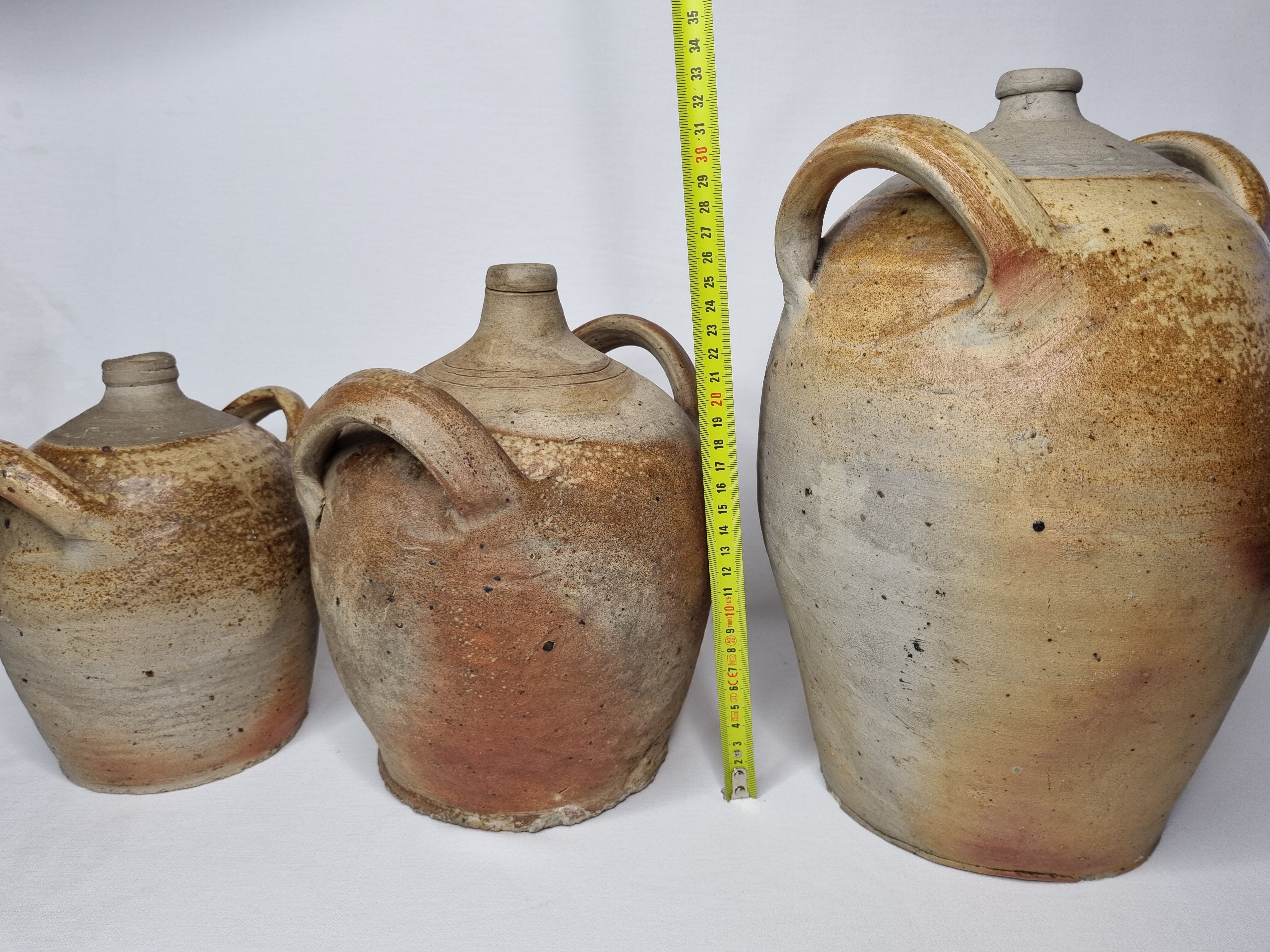 Set of three ancient ladies-jeannes in enamelled terracotta