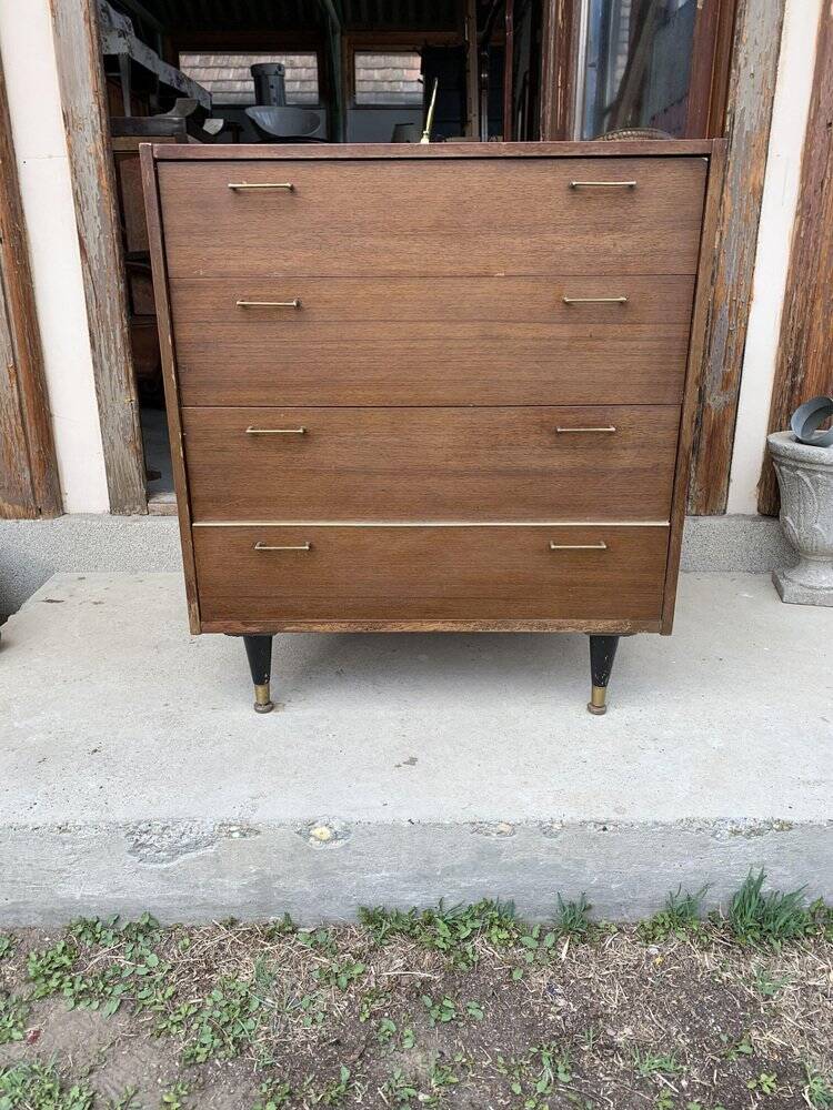 Mid-century teak chest of drawers in brown with four drawers, brass handles, 1960s.
