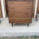 Mid-century teak chest of drawers in brown with four drawers, brass handles, 1960s.