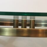 Console en acier brossé et laiton et plateau formé d'une dalle de verre. Travail français. Vers 1970