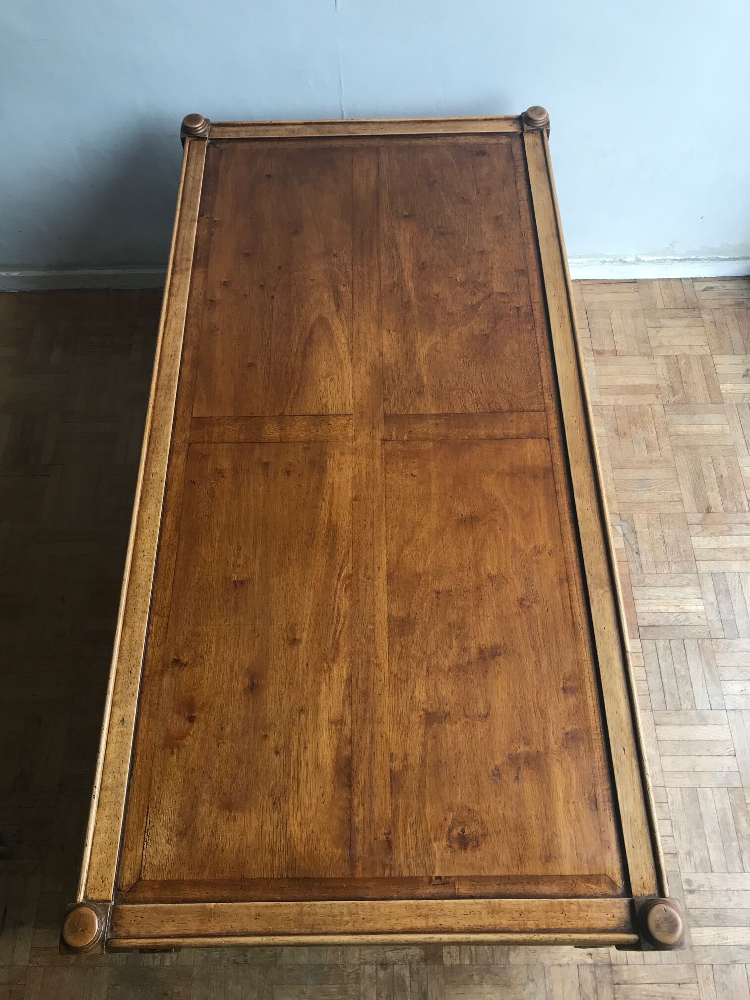 A solid wood-marked coffee table.