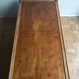 A solid wood-marked coffee table.