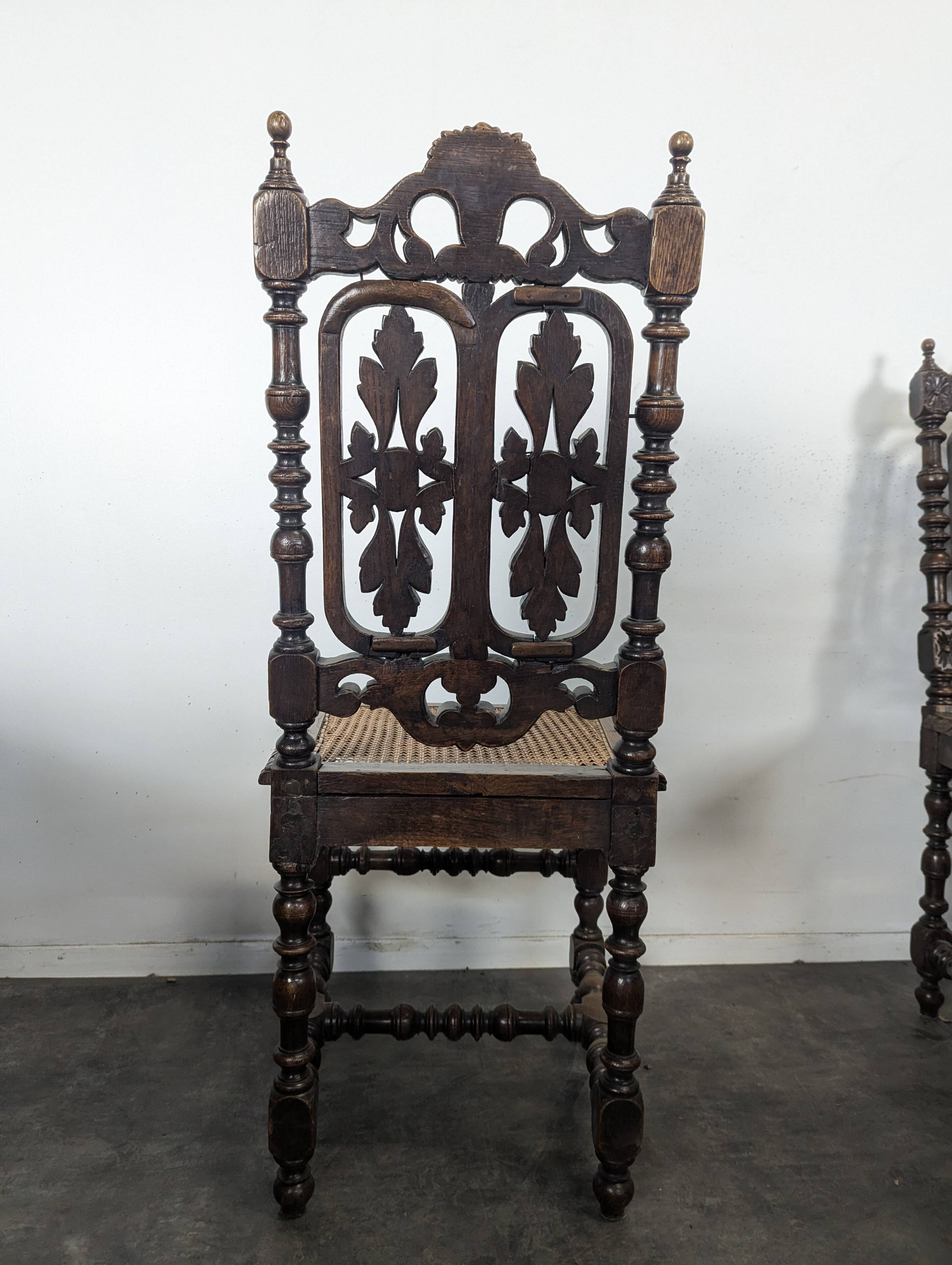 Set of 6 Henri II chairs in carved openwork oak with caned seats.
