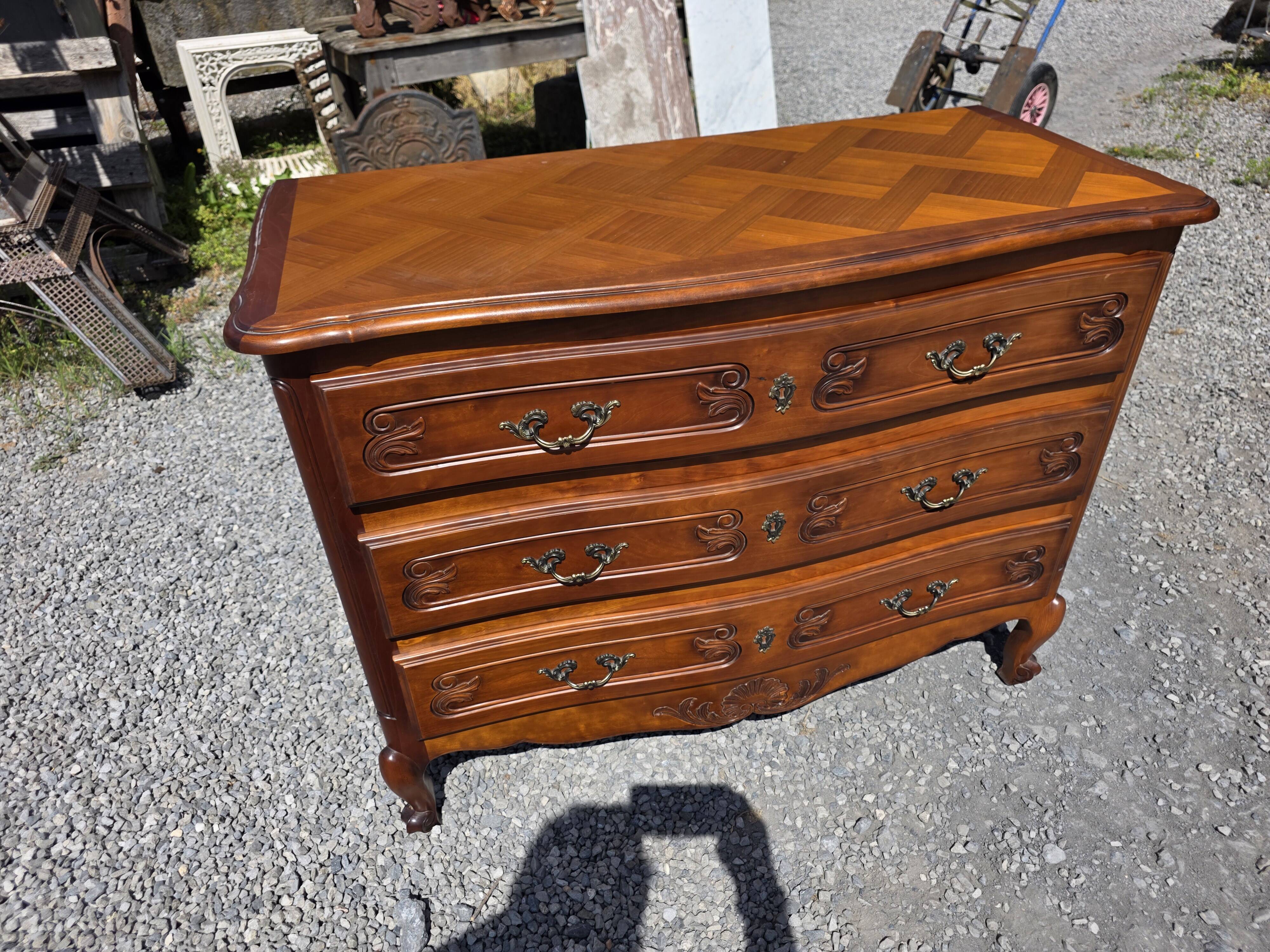 Curved commode in Louis XV style made of cherry wood.