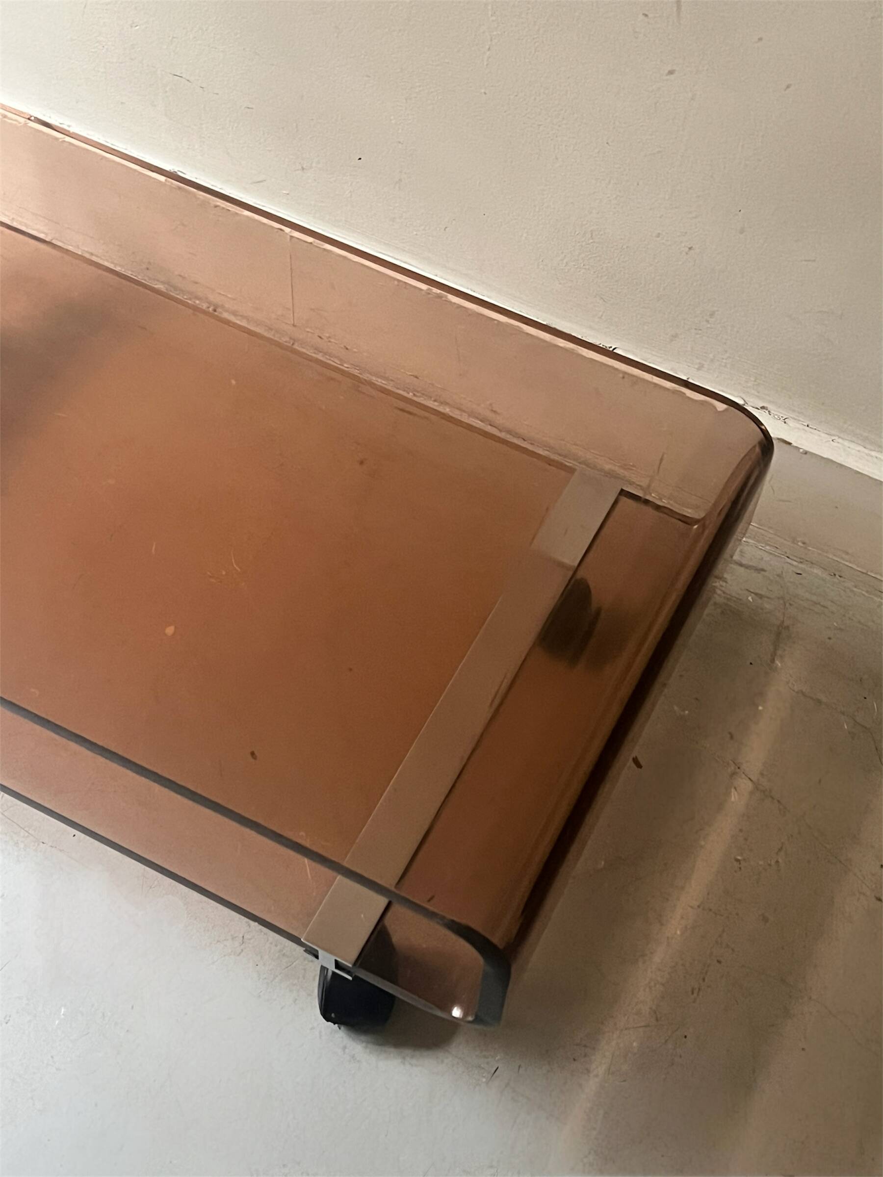 Smoked plexiglass coffee table on wheels, Roche Bobois design 1970.