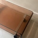 Smoked plexiglass coffee table on wheels, Roche Bobois design 1970.