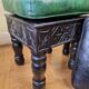 Pair of Moroccan poufs in stamped leather with a carved wooden base, Rabat