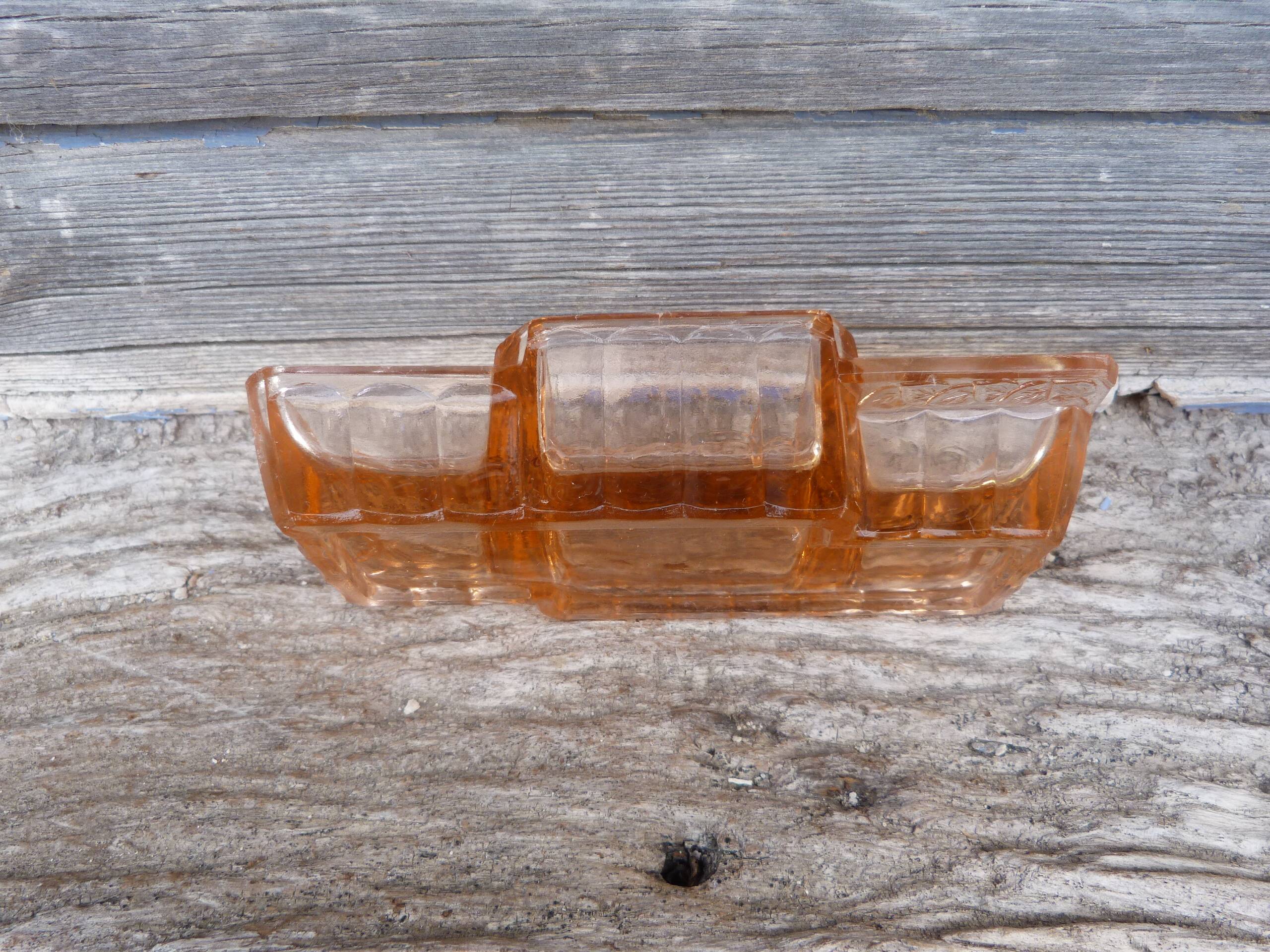 Glass condiment service in transparent pink moulded glass.