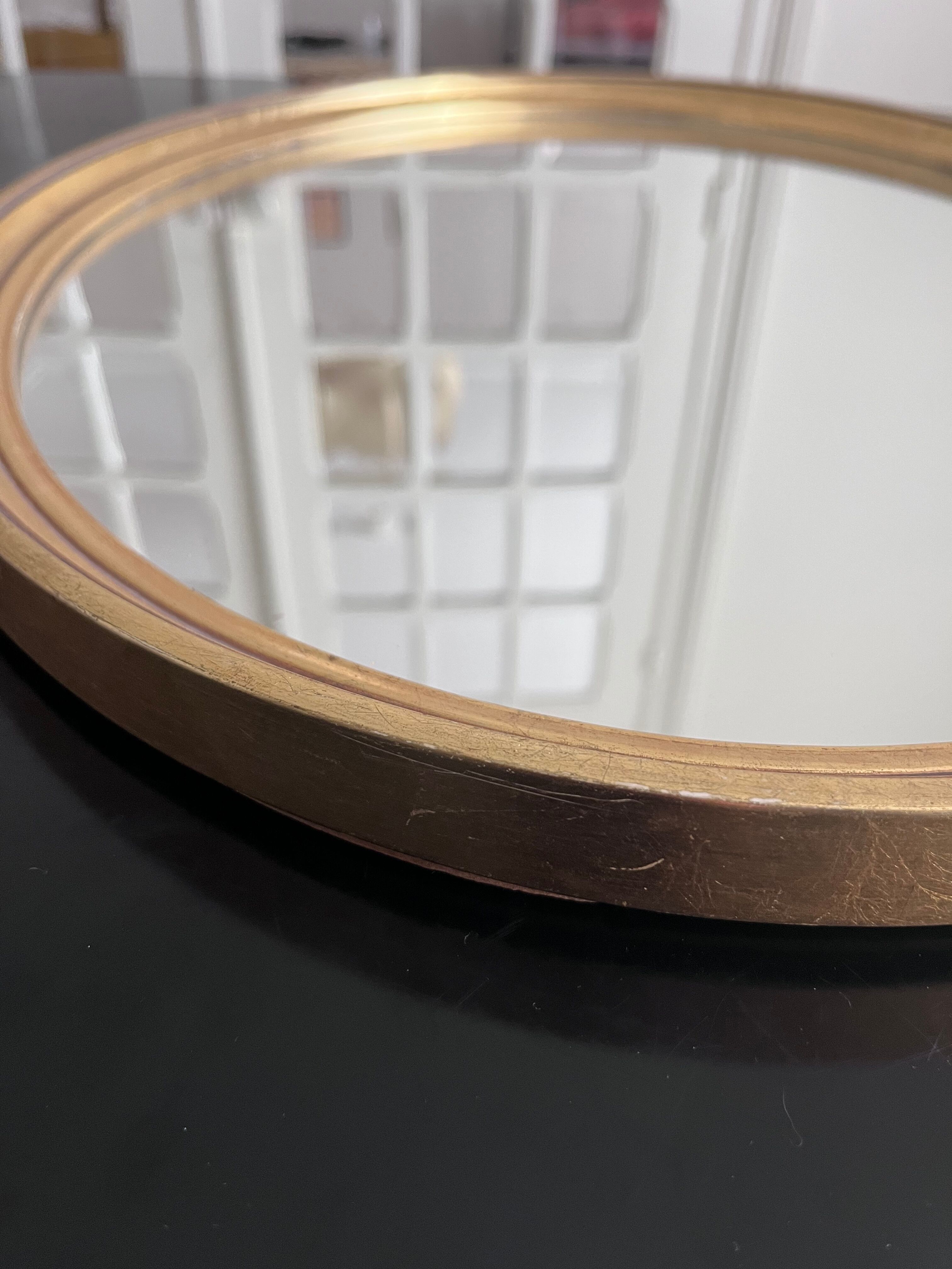 Oval mirror in gilded wood 43x53cm