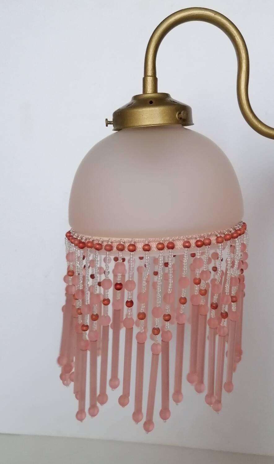 Pink glass wall lamp with garland of pearls