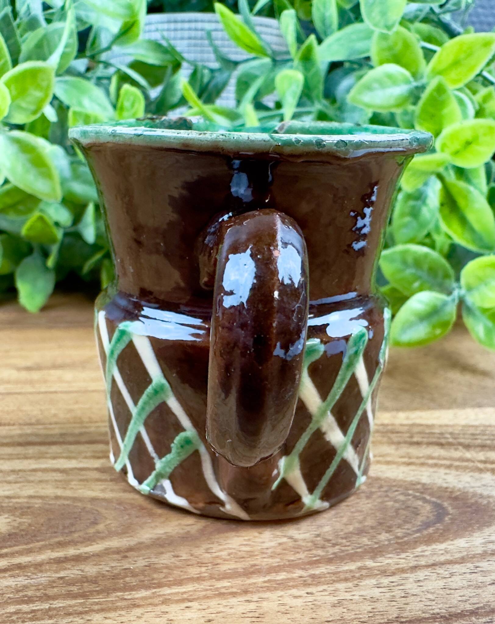 Small vintage ceramic jug in brown glazed with geometric design.
