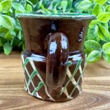 Small vintage ceramic jug in brown glazed with geometric design.