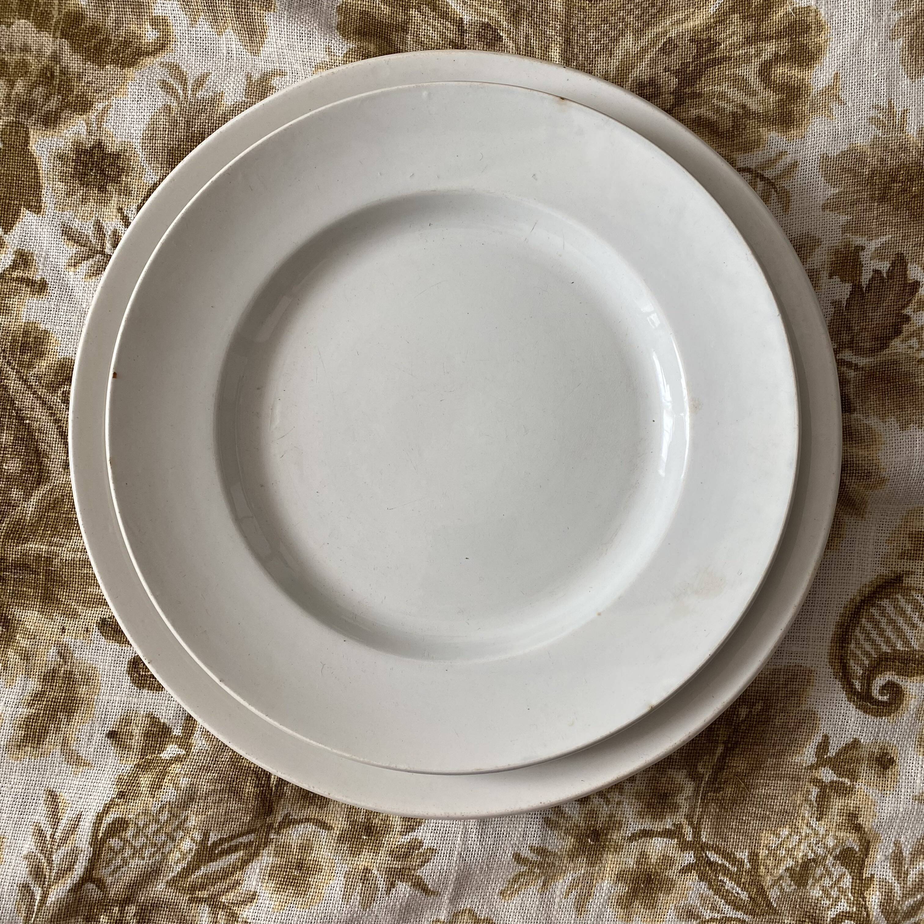 Set of large round white earthenware dishes from Creil and Montereau, 19th century